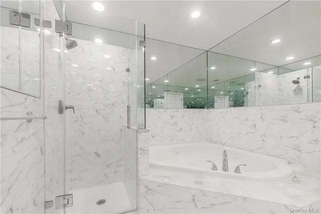 a bathroom with a bathtub and shower