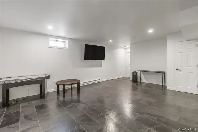 a view of an empty room with a chair and fireplace