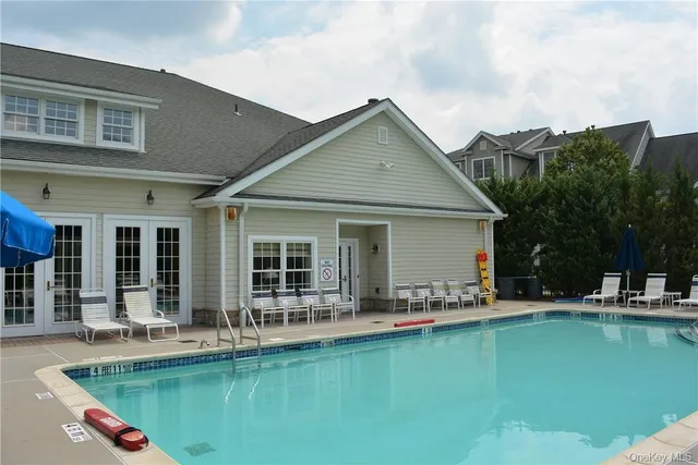 a front view of house with swimming pool yard and outdoor seating