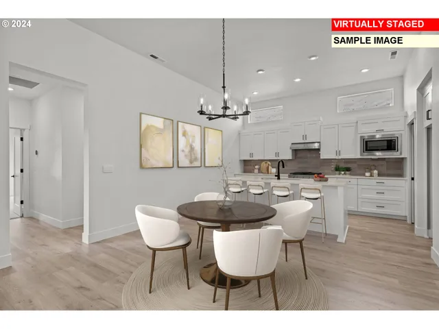 a view of a dining room with furniture a chandelier and wooden floor