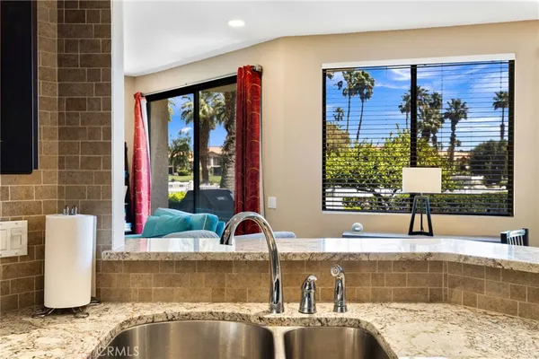 a view of a kitchen with a sink and a window