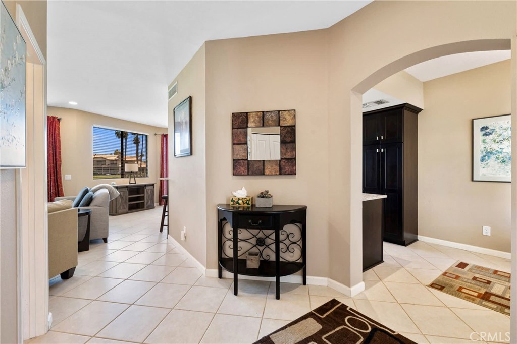 55108 Firestone La Quinta, CA 92253 - Photo 16 of 47 a kitchen with stainless steel appliances kitchen island granite countertop a refrigerator and a stove top oven