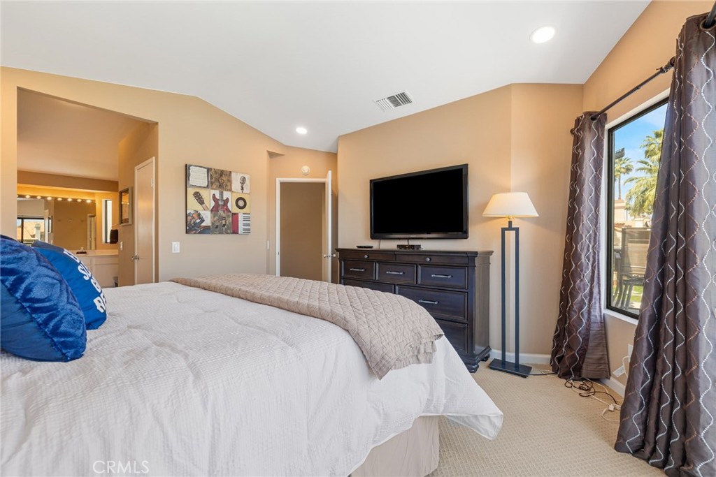 55108 Firestone La Quinta, CA 92253 - Photo 19 of 47 a bedroom with a bed and a flat screen tv