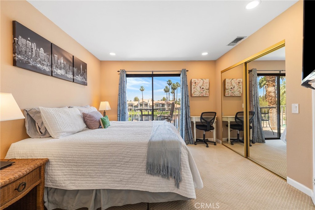 55108 Firestone La Quinta, CA 92253 - Photo 23 of 47 a bedroom with a large bed and a large window