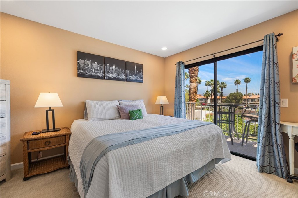 55108 Firestone La Quinta, CA 92253 - Photo 24 of 47 a bedroom with a balcony a bed and a lamp