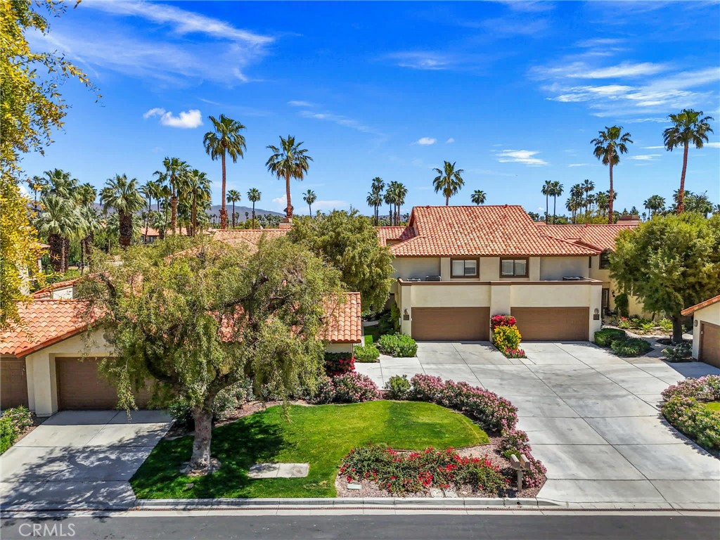 55108 Firestone La Quinta, CA 92253 - Photo 29 of 47 a front view of a house with a yard and potted plants
