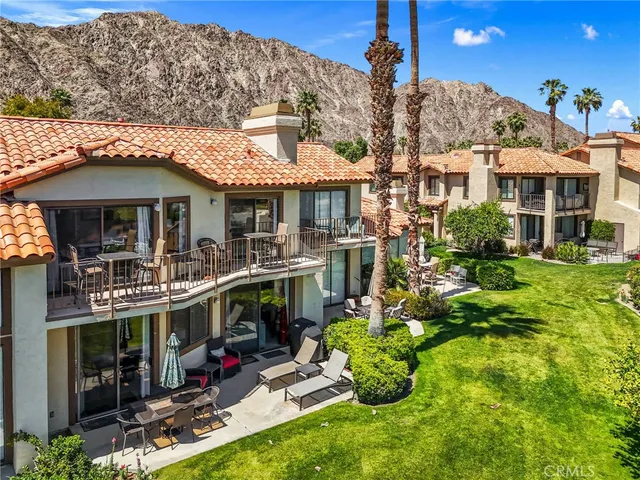 a view of a house with swimming pool and sitting area