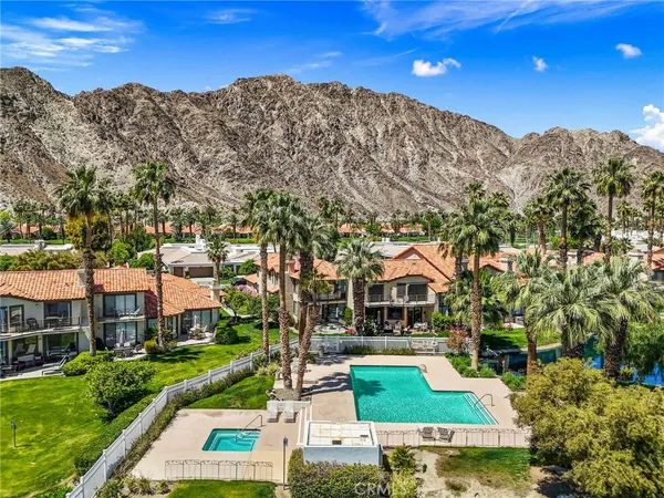 a view of a chair and tables in the balcony