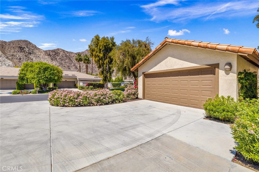 55108 Firestone La Quinta, CA 92253 - Photo 41 of 47 a front view of a house with a yard and garage