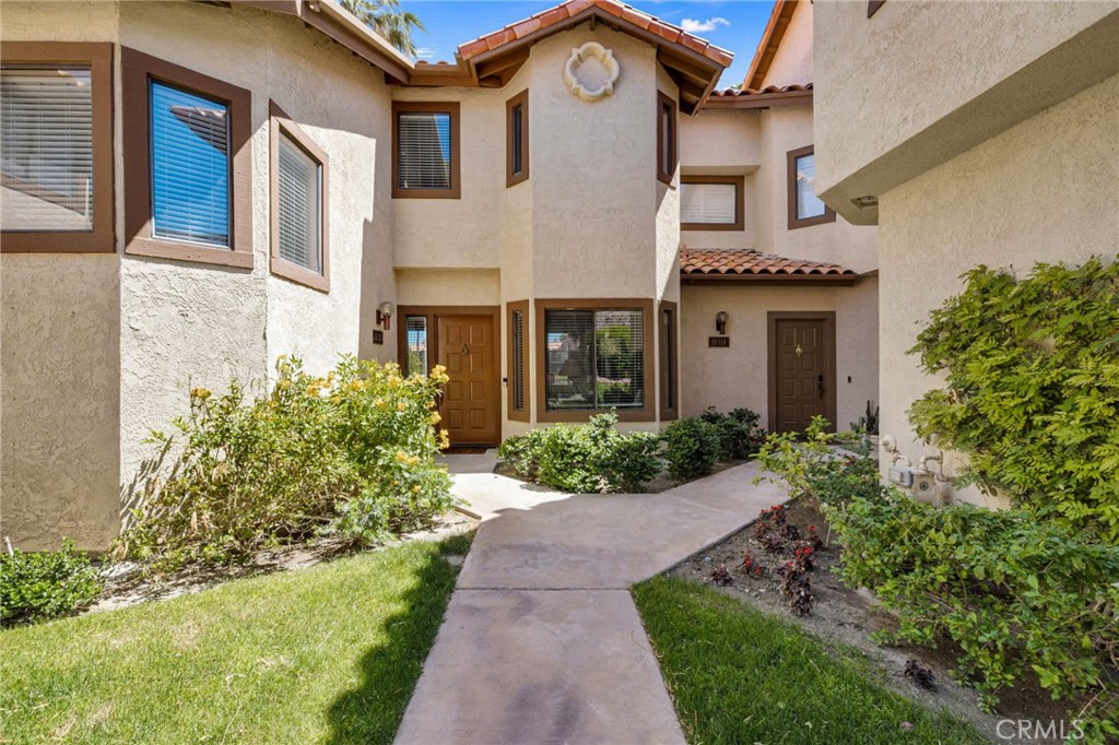 55108 Firestone La Quinta, CA 92253 - Photo 43 of 47 a front view of a house with a garden