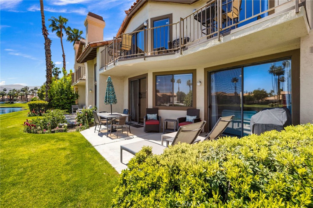 55108 Firestone La Quinta, CA 92253 - Photo 44 of 47 a view of a building with potted plants and a patio