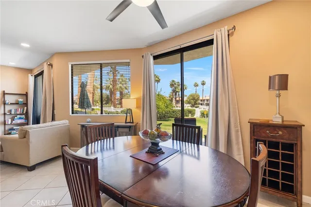 a dining room with furniture window and wooden floor