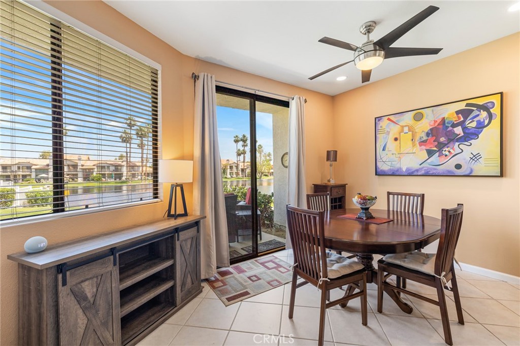 55108 Firestone La Quinta, CA 92253 - Photo 7 of 47 a dining room with a wooden table and chairs