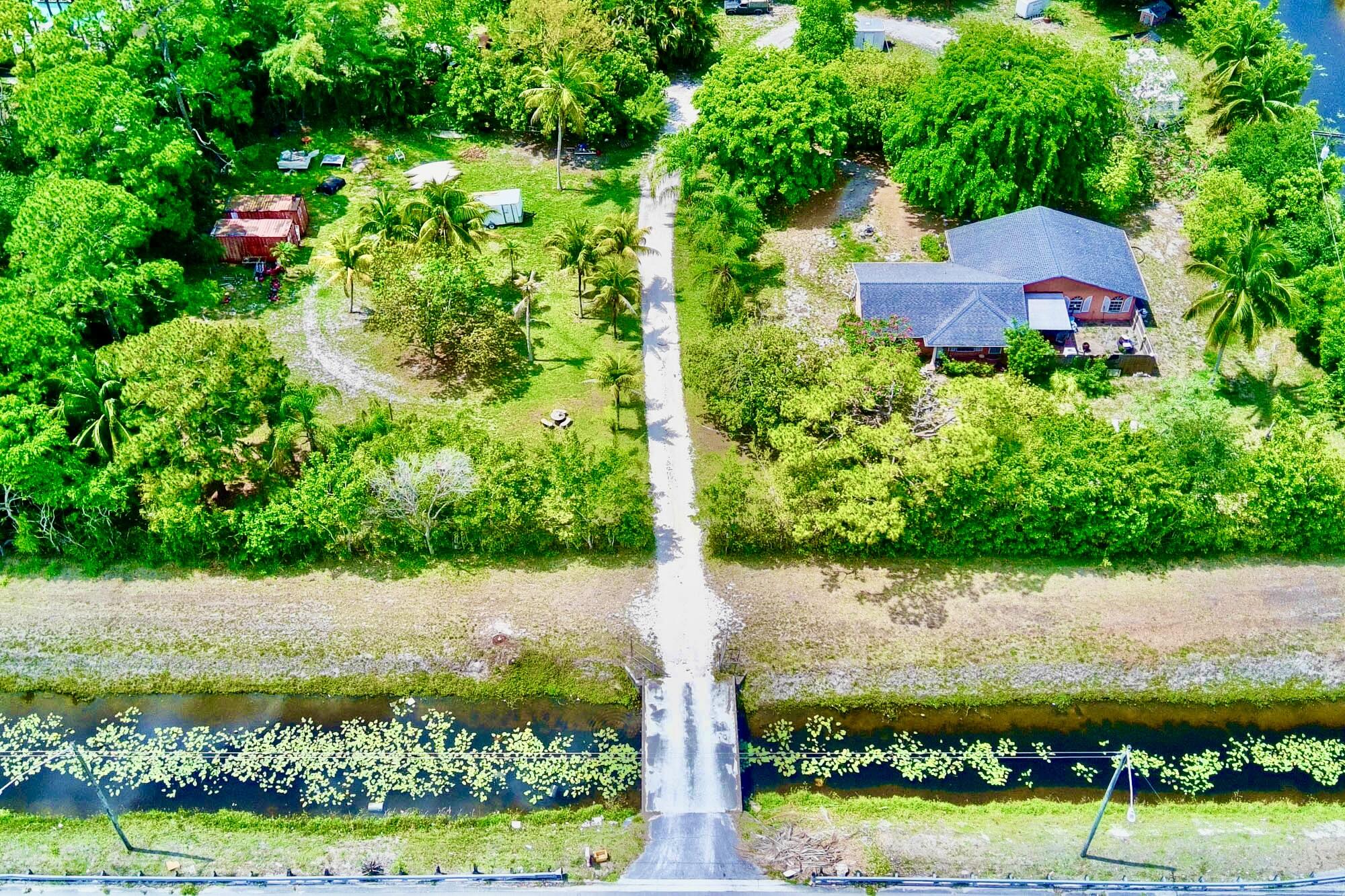 5947 Hypoluxo Road Lake Worth, FL 33463 - Photo 2 of 7 a view of a garden with plants and large trees