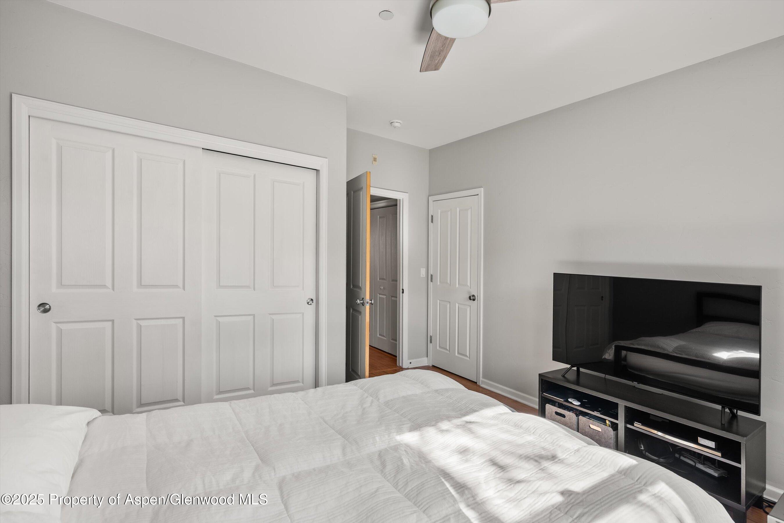 1330 East Valley Road Basalt, CO 81621 - Photo 16 of 18 a bedroom with a bed and a chandelier