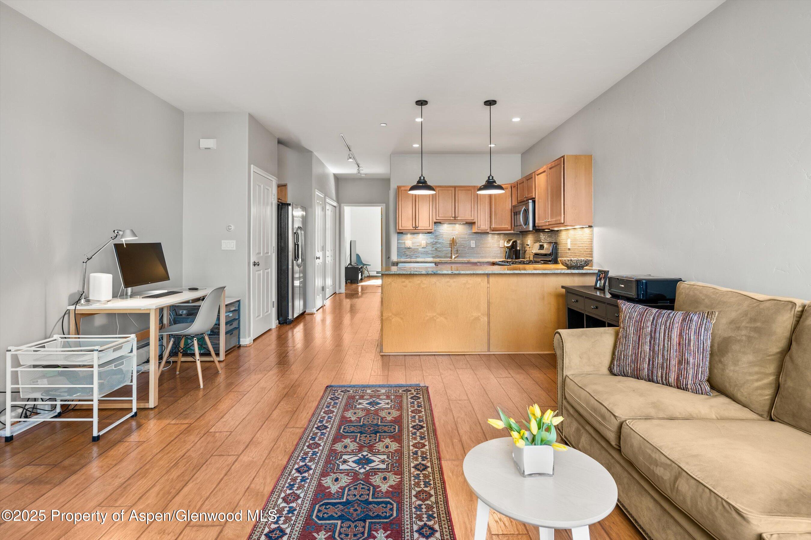 1330 East Valley Road Basalt, CO 81621 - Photo 8 of 18 a living room with stainless steel appliances furniture and a wooden floor
