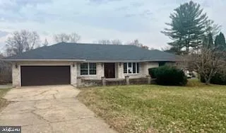 a view of a house with a yard and sitting area