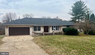 a view of a house with a yard and sitting area