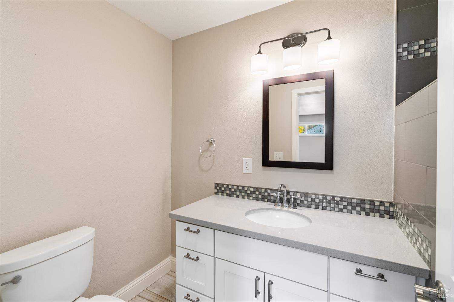2136 Franklin Avenue Santa Rosa, CA 95404 - Photo 17 of 22 a bathroom with a sink a toilet and mirror