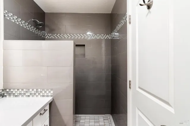 a bathroom with a shower and a sink