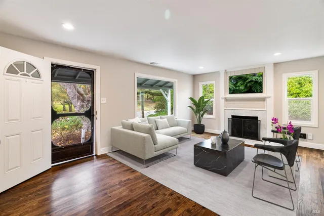 a living room with furniture and a fireplace