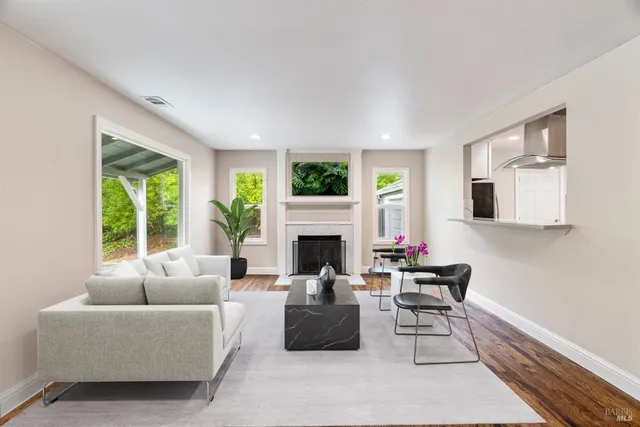 a living room with furniture fireplace and window