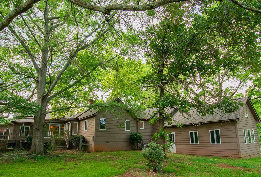 200 Chenault Road Townville, SC 29689 - Photo 45 of 47 Mature trees shade this home's verdant backyard, complete with a deck for outdoor enjoyment.