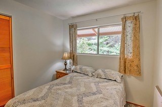 19-3940 Hoonanea Street Volcano, HI 96785 - Photo 20 of 30 a bedroom with a bed and a window