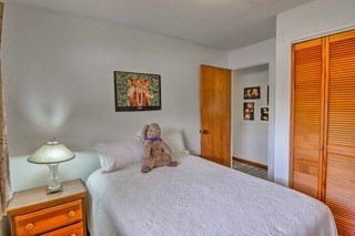 19-3940 Hoonanea Street Volcano, HI 96785 - Photo 22 of 30 a bedroom with a bed and a lamp on table
