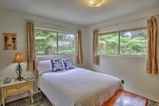 19-3940 Hoonanea Street Volcano, HI 96785 - Photo 24 of 30 a bedroom with a bed and a window