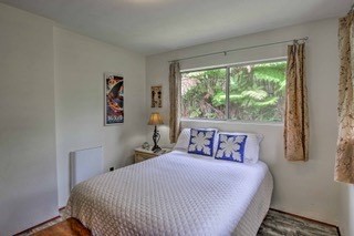 19-3940 Hoonanea Street Volcano, HI 96785 - Photo 25 of 30 a bedroom with a large bed and a window