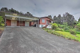 19-3940 Hoonanea Street Volcano, HI 96785 - Photo 26 of 30 a front view of a house with a yard and potted plants