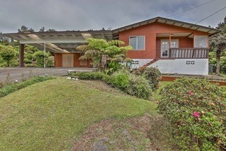 19-3940 Hoonanea Street Volcano, HI 96785 - Photo 3 of 30 a front view of a house with a yard