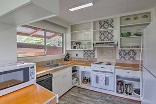 19-3940 Hoonanea Street Volcano, HI 96785 - Photo 7 of 30 a kitchen with stainless steel appliances a sink a stove and a refrigerator