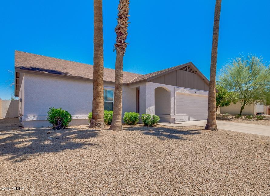 6320 Casper Road Mesa, AZ 85205 - Photo 1 of 35 a front view of a house with a yard and garage