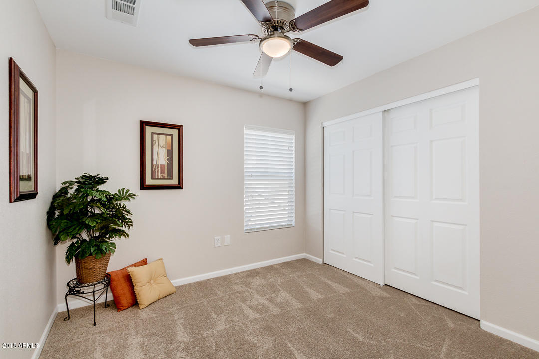 6320 Casper Road Mesa, AZ 85205 - Photo 23 of 35 a view of an empty room with a window and a ceiling fan