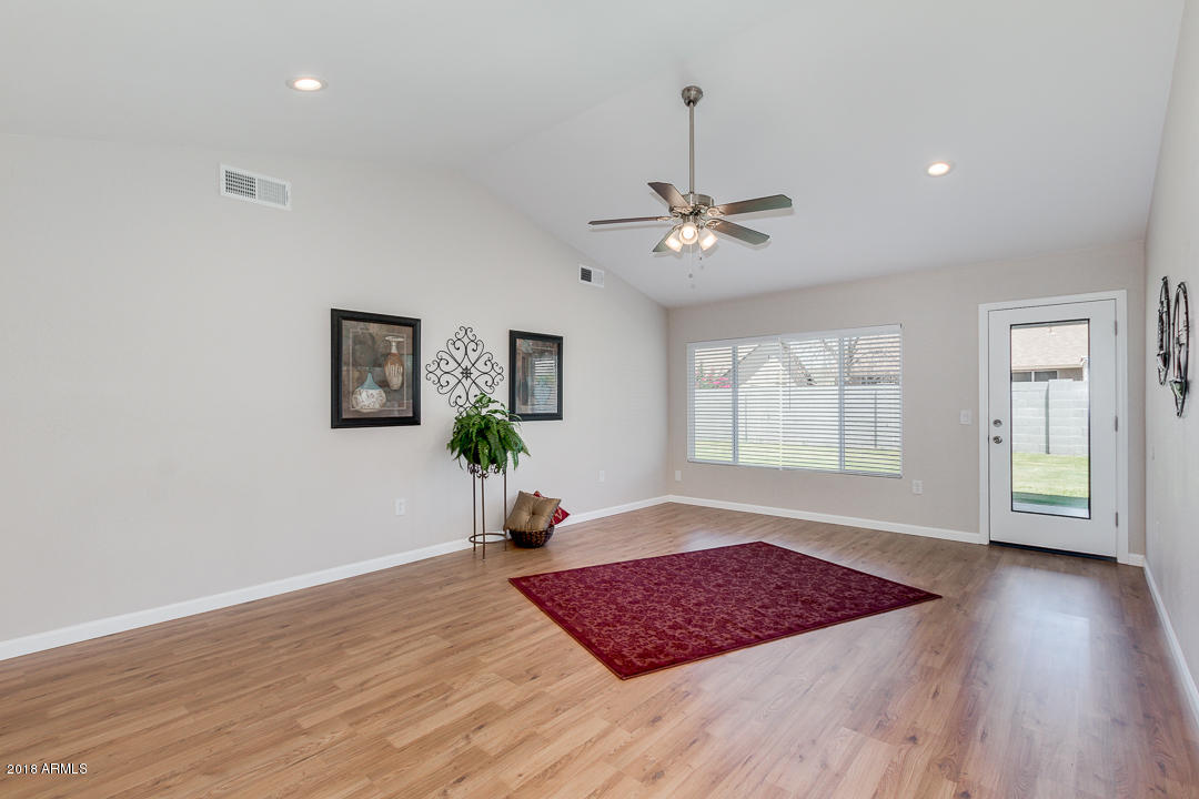 6320 Casper Road Mesa, AZ 85205 - Photo 7 of 35 a view of an empty room with window and wooden floor