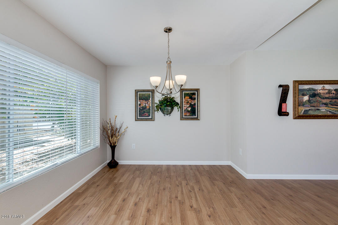 6320 Casper Road Mesa, AZ 85205 - Photo 8 of 35 a view of a room with wooden floor chandelier and windows