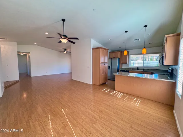 a view of a kitchen with furniture and wooden floor