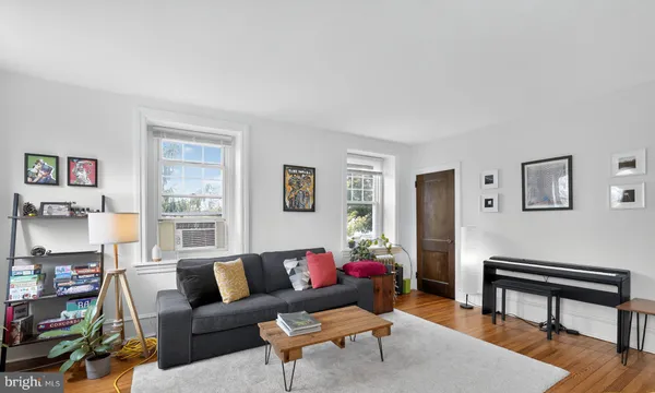 a living room with furniture a rug and a window