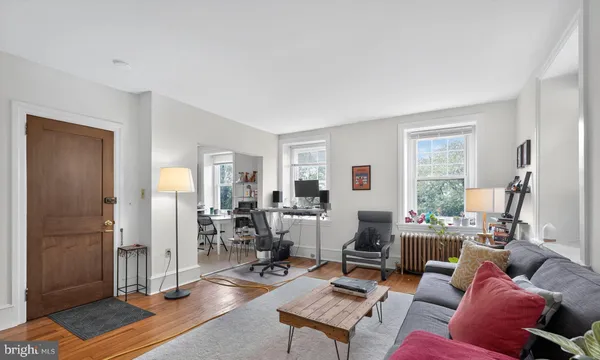 a living room with furniture a window and a table