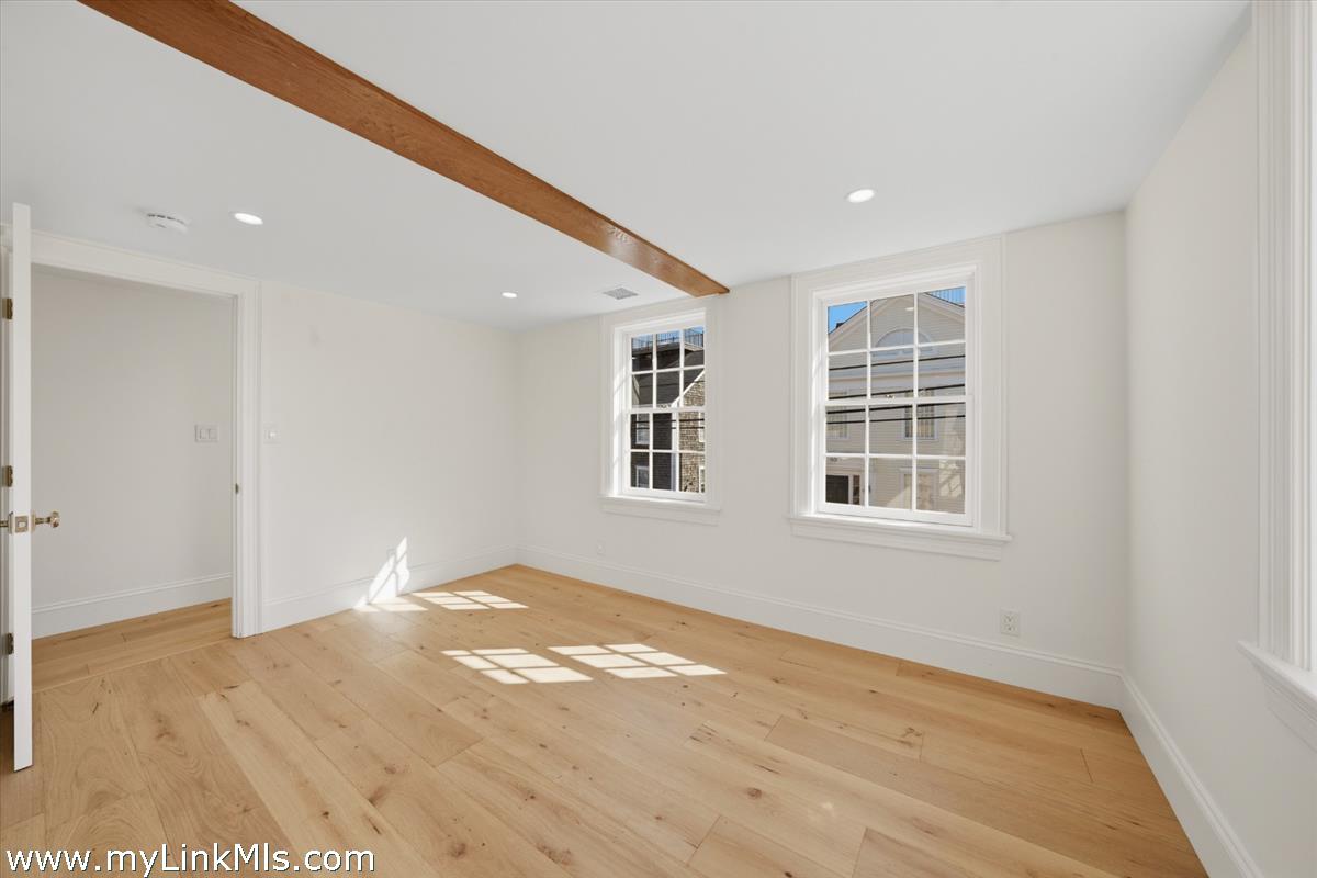 85 Orange Street Nantucket, MA 02554 - Photo 69 of 89 an empty room with wooden floor and windows