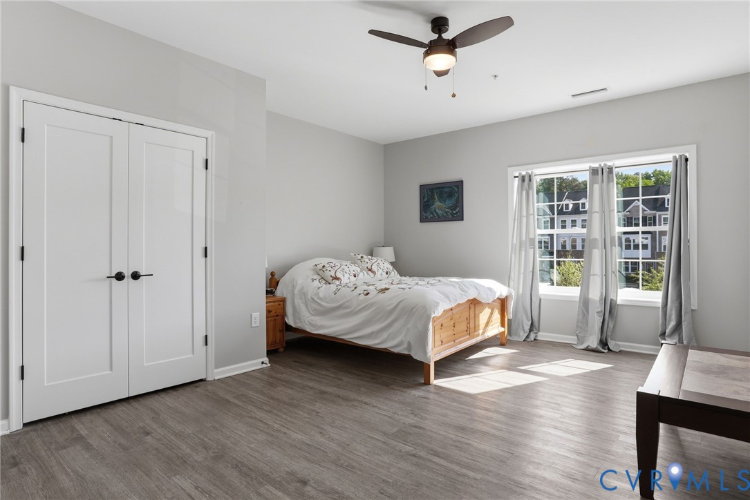1504 Ewing Pk Loop, Unit 201 Midlothian, VA 23113 - Photo 12 of 18 a bedroom with a bed and wooden floor
