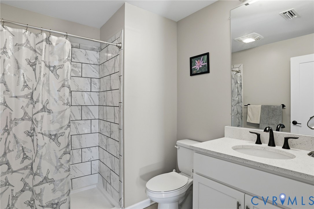 1504 Ewing Pk Loop, Unit 201 Midlothian, VA 23113 - Photo 14 of 18 a bathroom with a sink toilet and shower