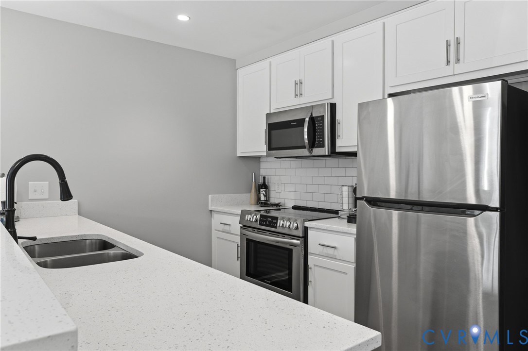 1504 Ewing Pk Loop, Unit 201 Midlothian, VA 23113 - Photo 8 of 18 a kitchen with a refrigerator sink and microwave