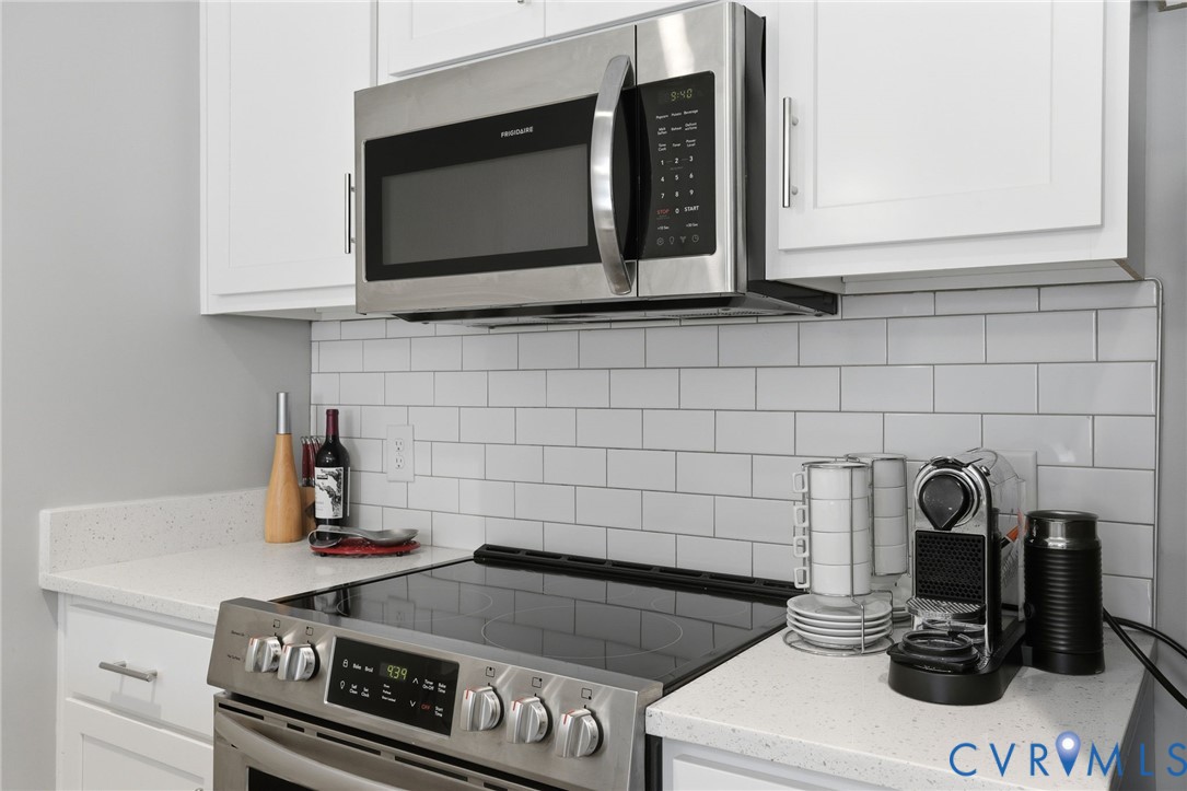 1504 Ewing Pk Loop, Unit 201 Midlothian, VA 23113 - Photo 10 of 18 a kitchen with a stove and a microwave