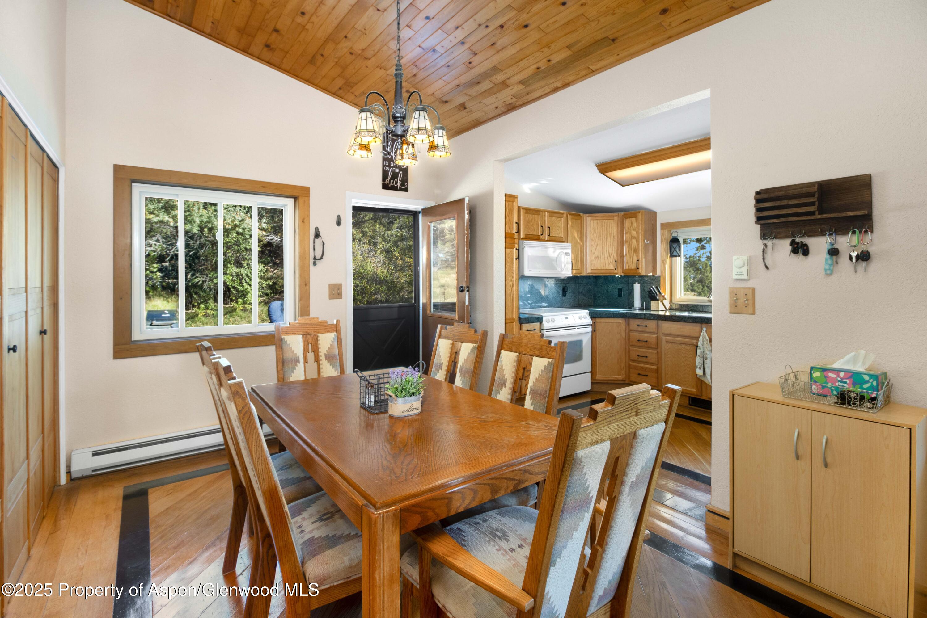 1849 Odin Drive Silt, CO 81652 - Photo 9 of 28 a view of a dining room with furniture window and wooden floor