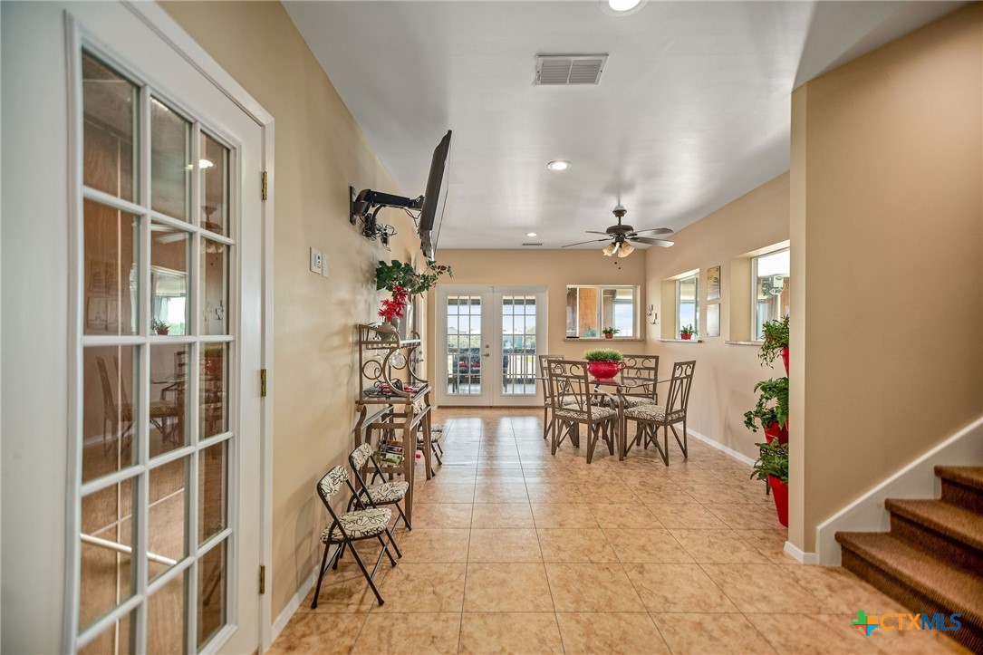 265 Coastal Oaks Loop Port O'Connor, TX 77982 - Photo 17 of 48 a view of a dining room with furniture and a chandelier