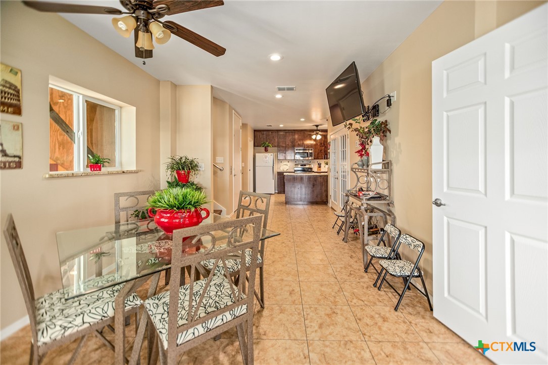 265 Coastal Oaks Loop Port O'Connor, TX 77982 - Photo 18 of 48 a view of a dining room with furniture and a chandelier