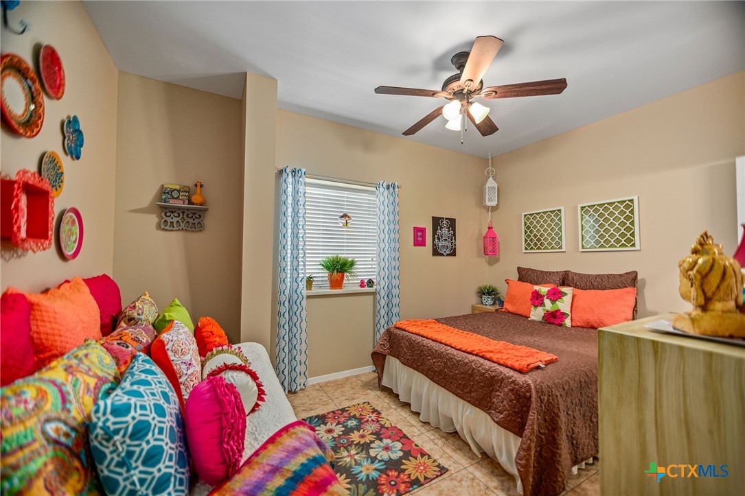 265 Coastal Oaks Loop Port O'Connor, TX 77982 - Photo 26 of 48 a bedroom that has a bed and a chandelier in it